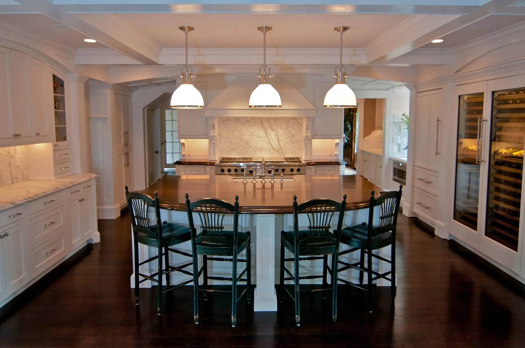 Custom white kitchen cabinetry with a large island